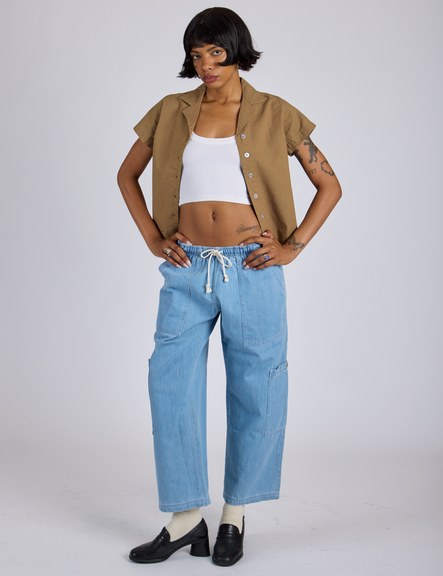 Kira is wearing Pantry Button-Up in Desert Brown and light wash Denim Drop Pocket Pants