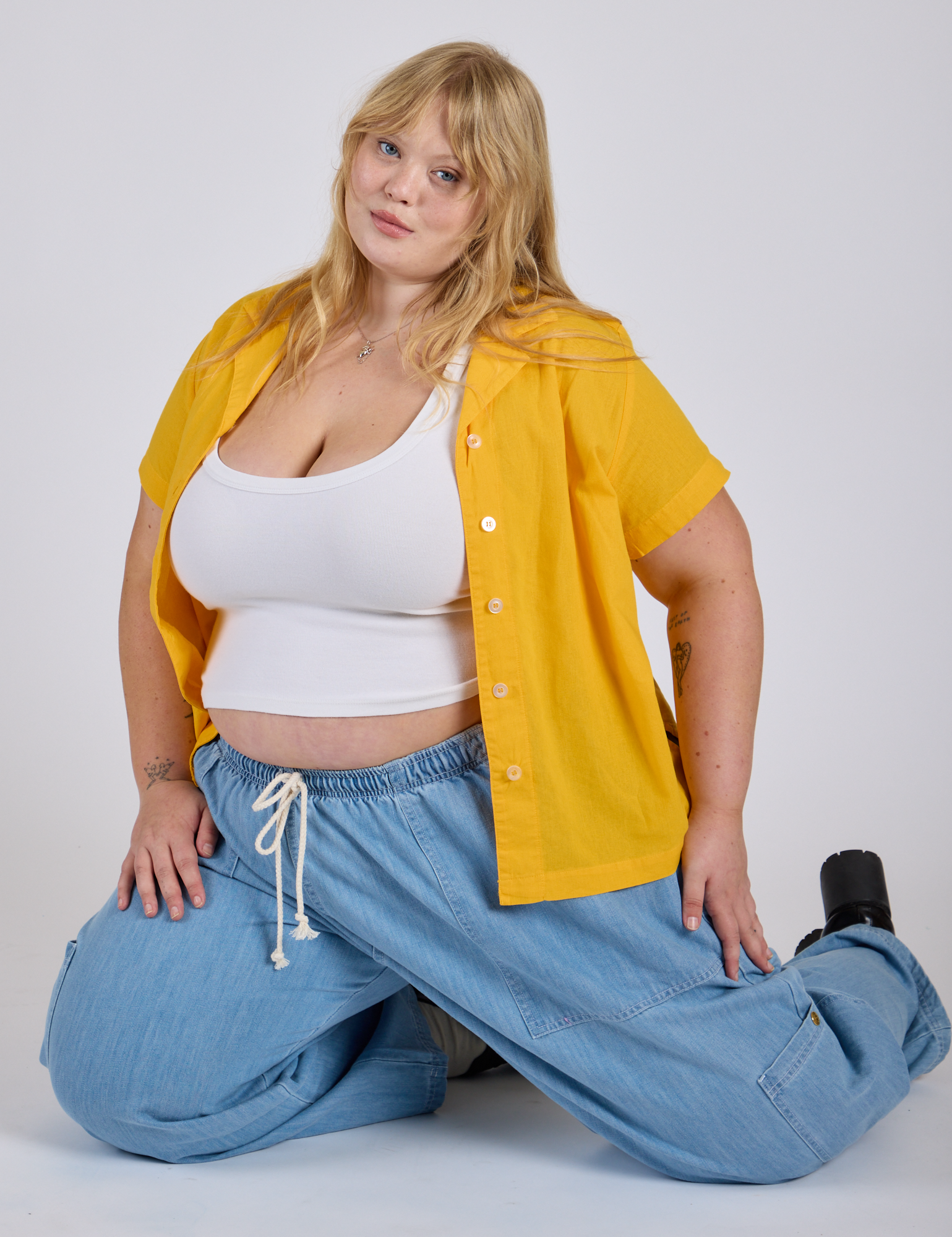 Juliet is wearing Pantry Button-Up in Sunshine Yellow and a Cropped Tank in Vintage Tee White underneath
