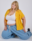 Juliet is wearing Pantry Button-Up in Sunshine Yellow and a Cropped Tank in Vintage Tee White underneath