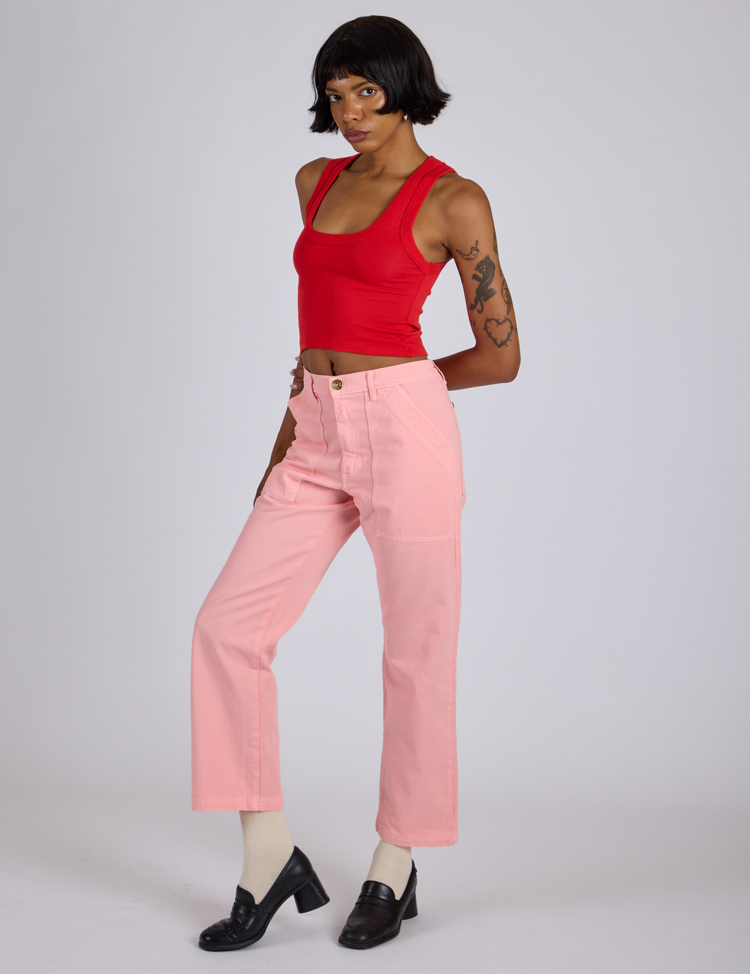 Angled front view of Work Pants in Baby Pink and mustang red Cropped Tank