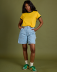 Kandia is wearing Vintage Ringer Tee in Sunshine Yellow and light wash Carpenter Shorts
