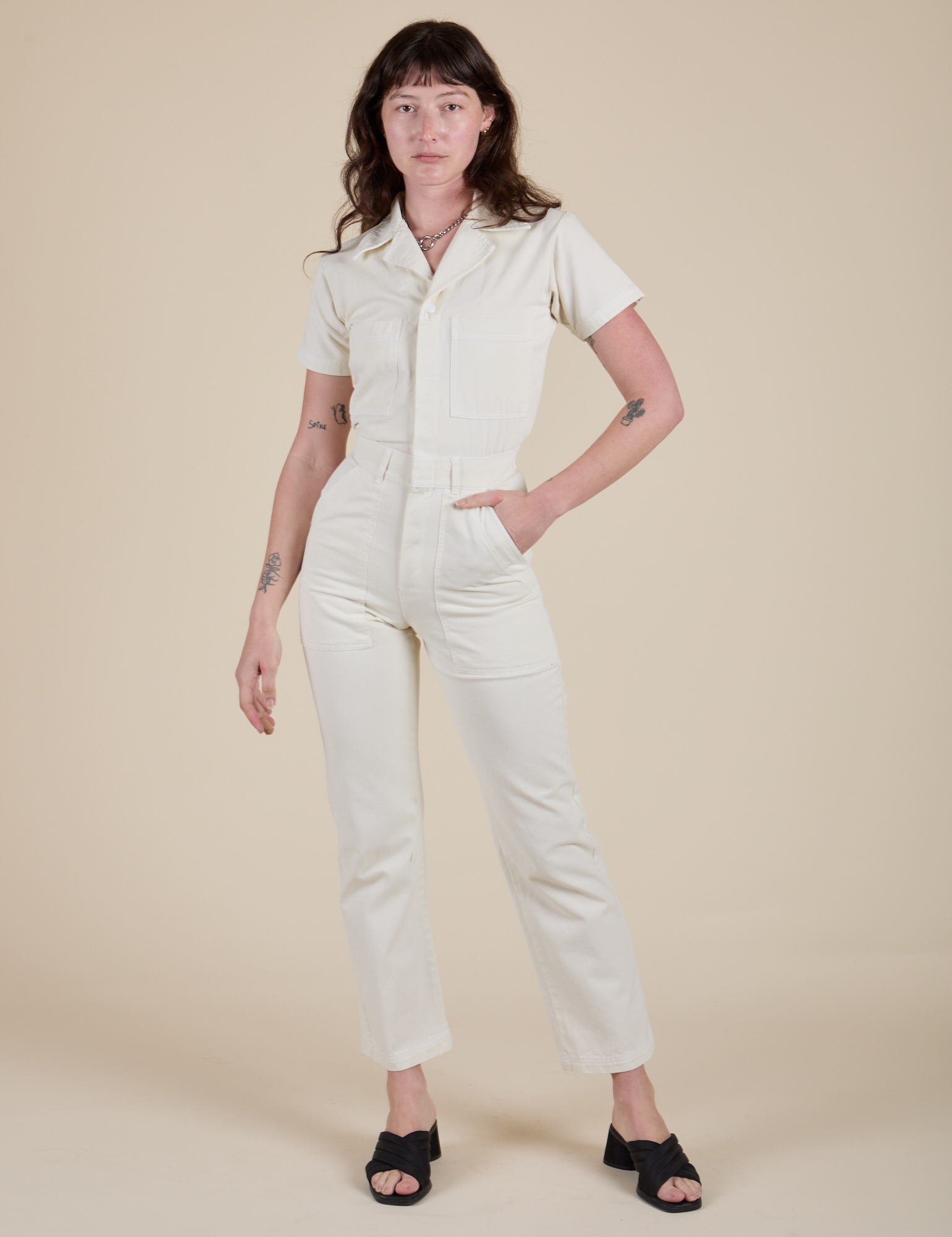 Alex is 5'8" and wearing XS Short Sleeve Jumpsuit in Vintage Tee White