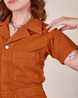 Front close up of Short Sleeve Jumpsuit in Burnt Terracotta worn by Alex