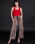 Alex is wearing Striped Drop Pocket Pants in Retro Rainbow and mustang red Tank Top