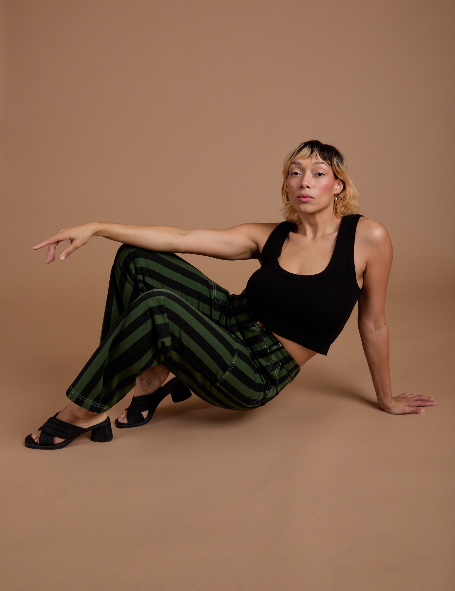 Tiara is wearing Black Stripe Work Pants in Evergreen