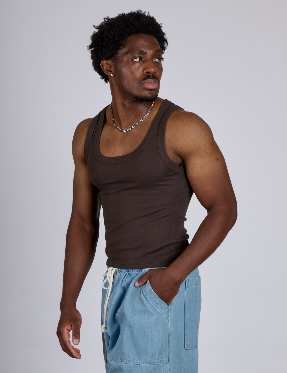 Angled front view of The Tank Top in Espresso Brown on Isaac