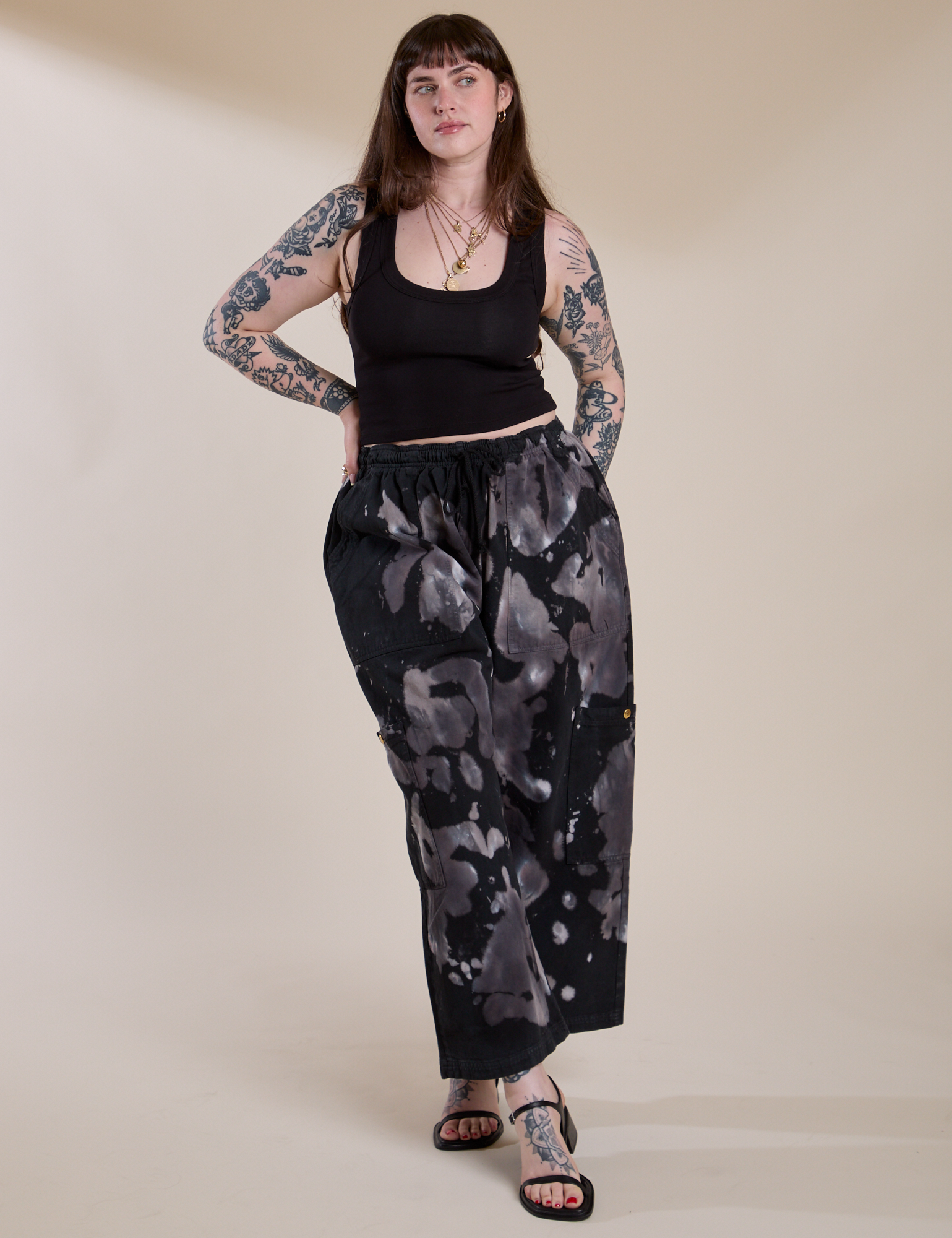 Sydney is wearing Magic Waters Drop Pocket Pants in Ink Blot and black Cropped Tank Top