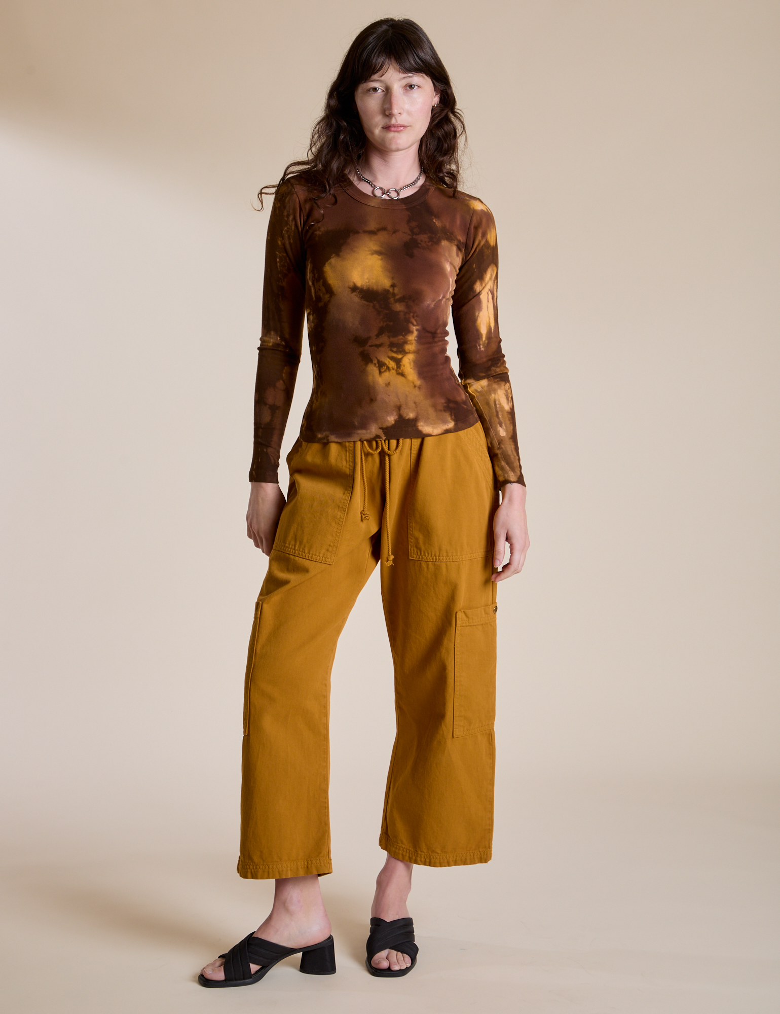 Alex is wearing Long Sleeve Baby Tee in Honey Brown paired with spicy mustard Drop Pocket Cargo Pants