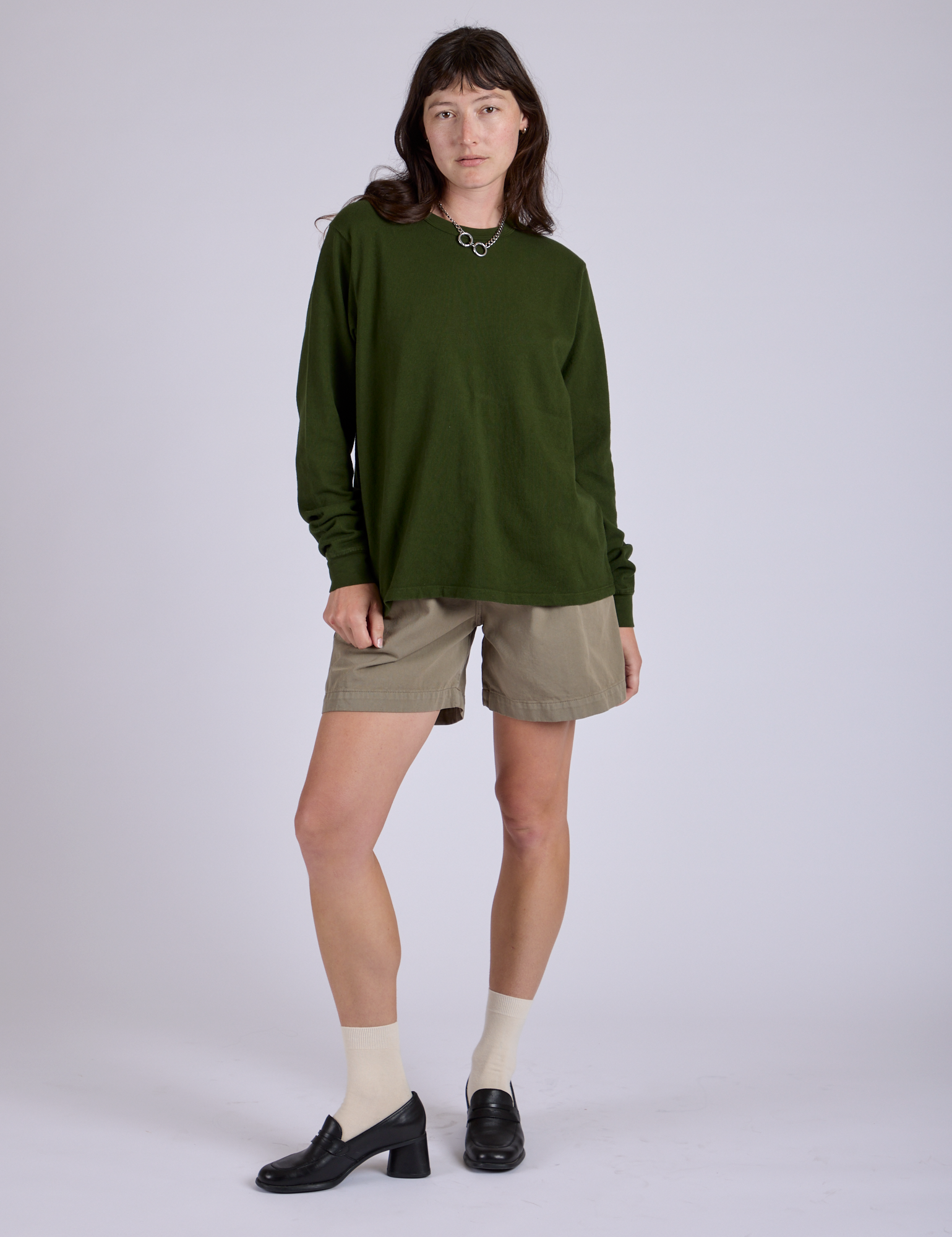 Alex is wearing Pleated Trouser Shorts in Khaki Grey and Long Sleeve Burly Tee in Evergreen