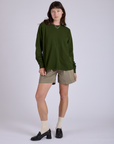 Alex is wearing Pleated Trouser Shorts in Khaki Grey and Long Sleeve Burly Tee in Evergreen