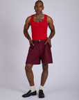 Jerrod is wearing Pleated Trouser Shorts in Red Wine and mustang red Cropped Tank