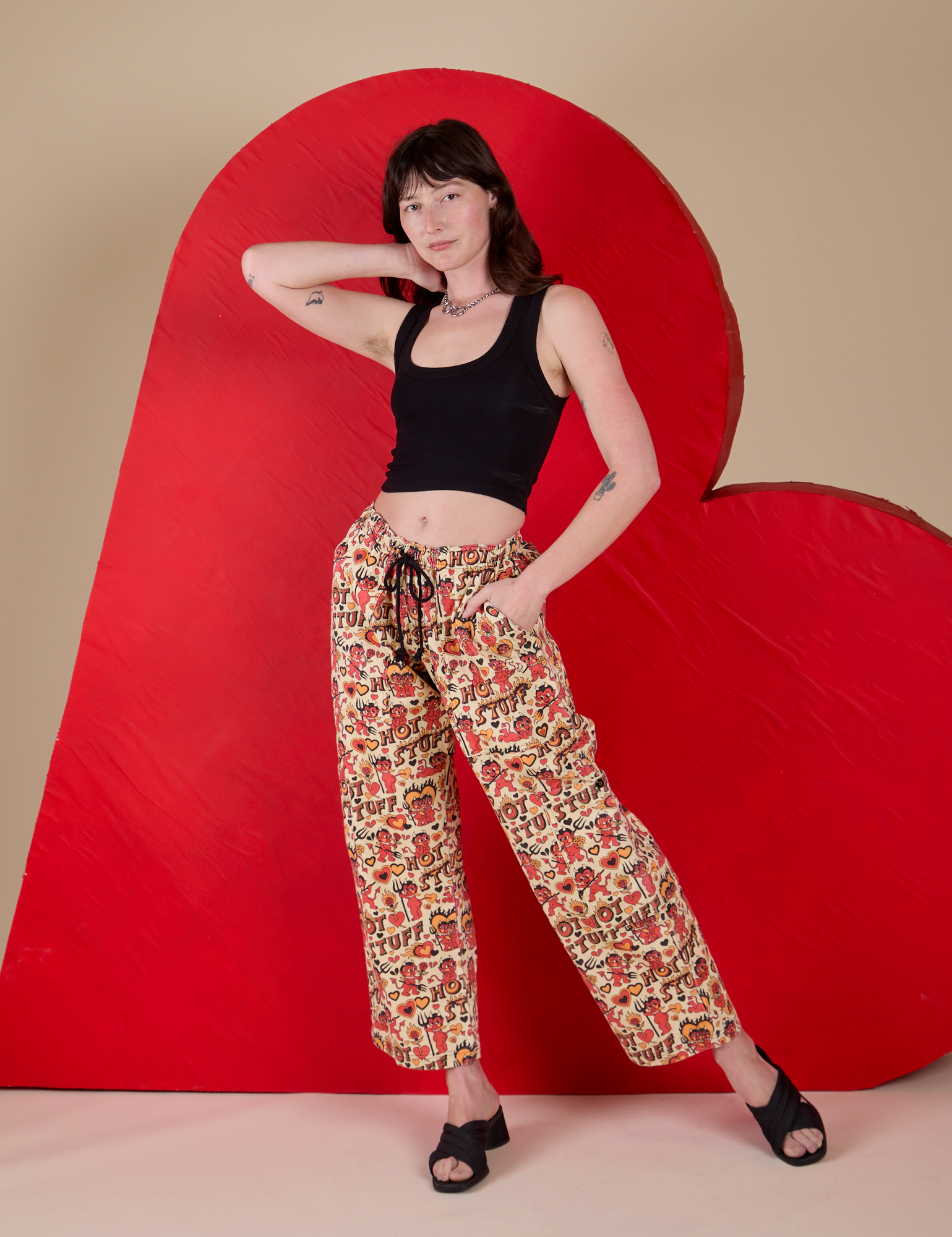 Alex is wearing  Hot Stuff Drop Pocket Cargo Pants and black Cropped Tank