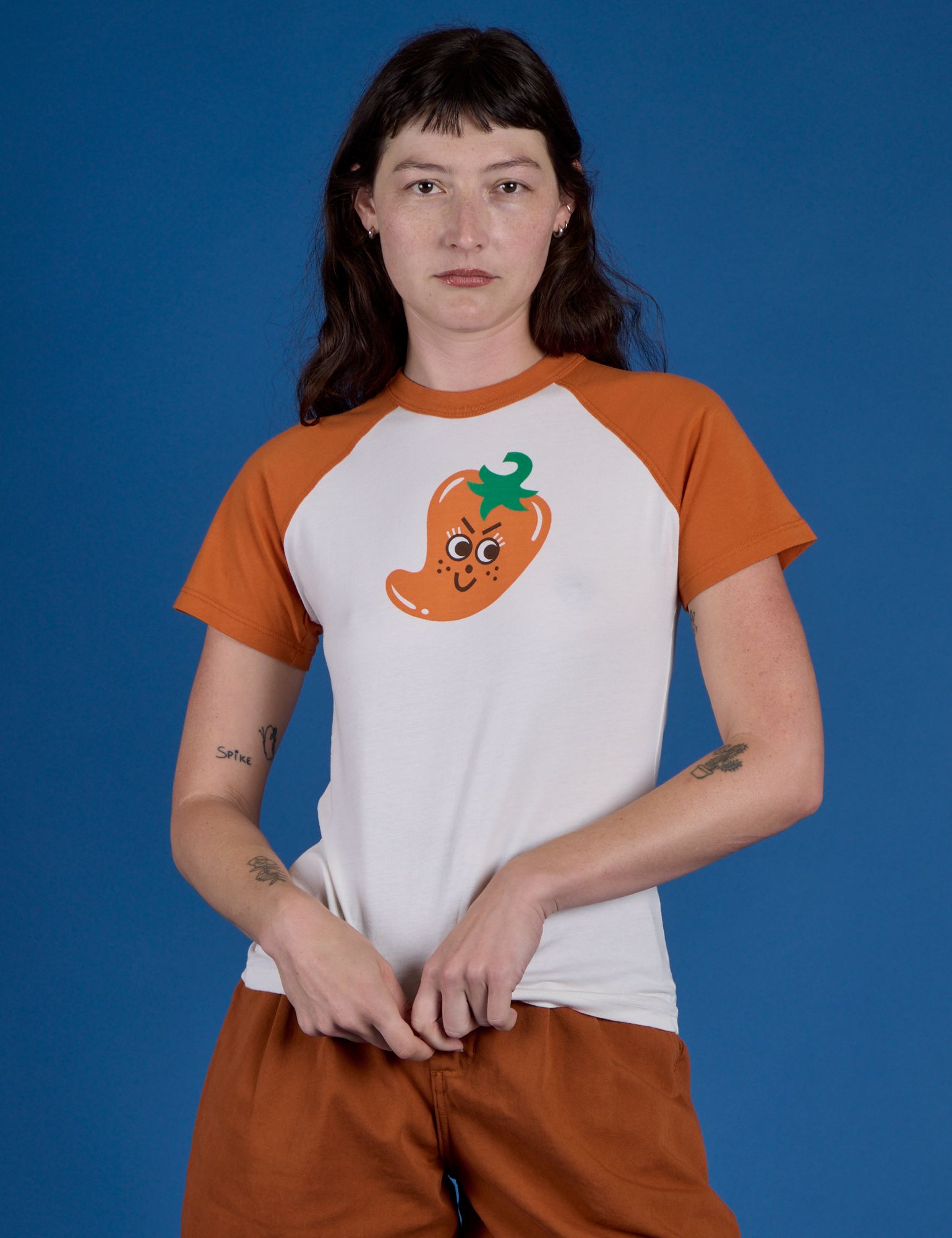 Alex is 5’8” and wearing P Produce Raglan Tee in Habanero