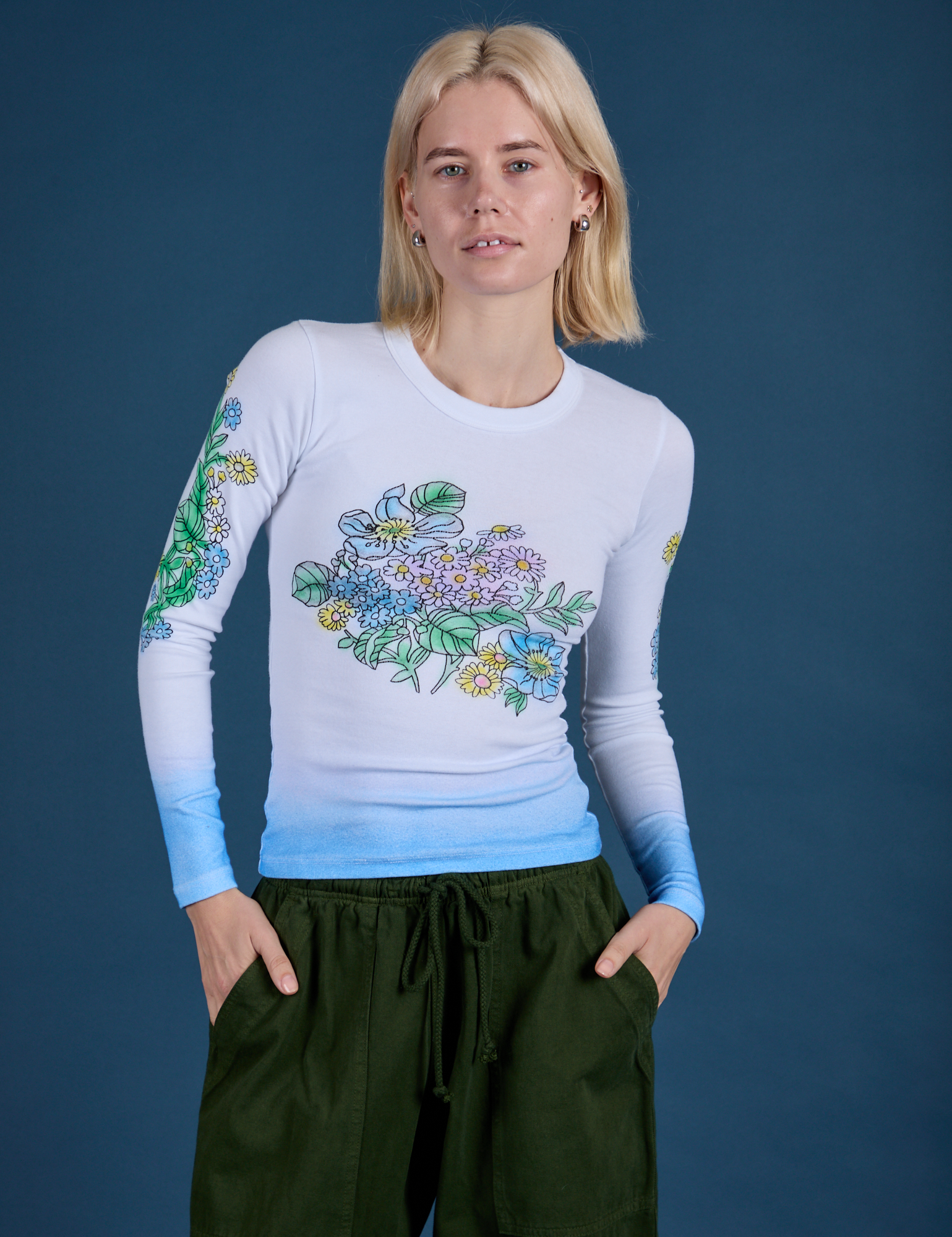 Madeline is 5’9” and wearing P Floral Long Sleeve Baby Tee in Baby Blue