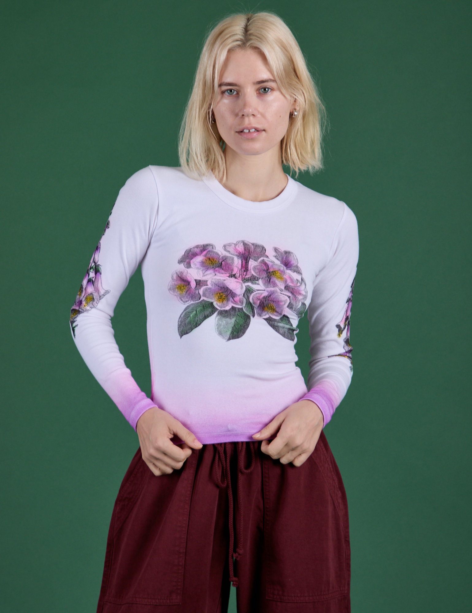 Madeline is 5’9” and wearing P Floral Long Sleeve Baby Tee in Pink