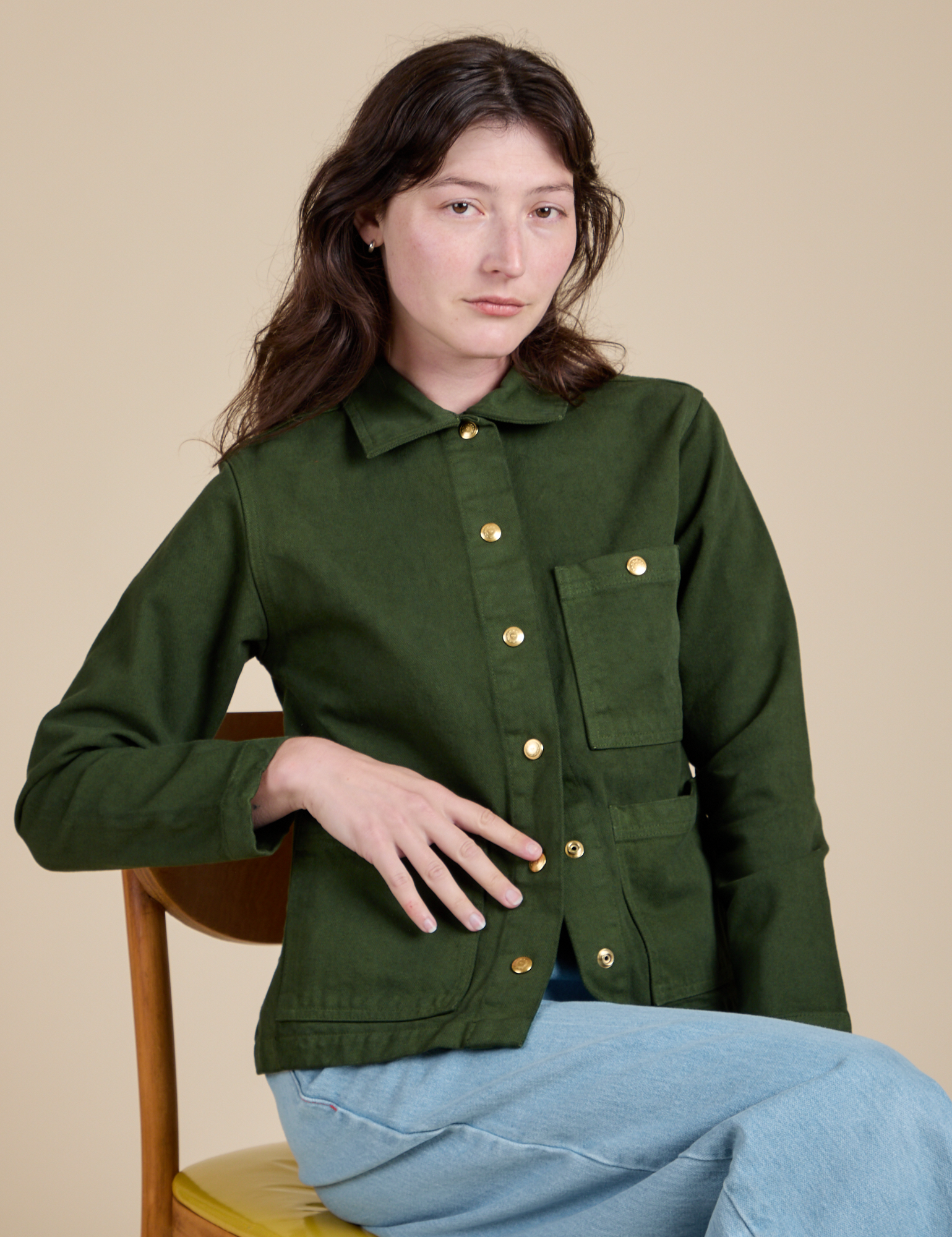 Alex is wearing a buttoned up Denim Work Jacket in Evergreen