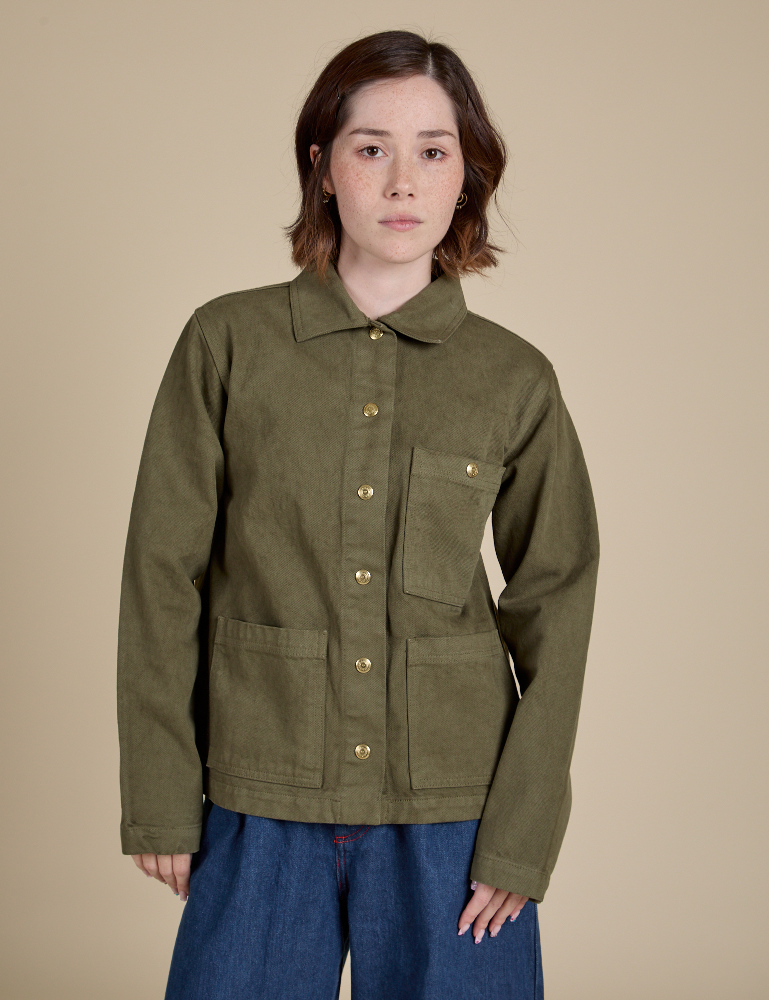 Hana is 5'3" and wearing P Denim Work Jacket in Surplus Green
