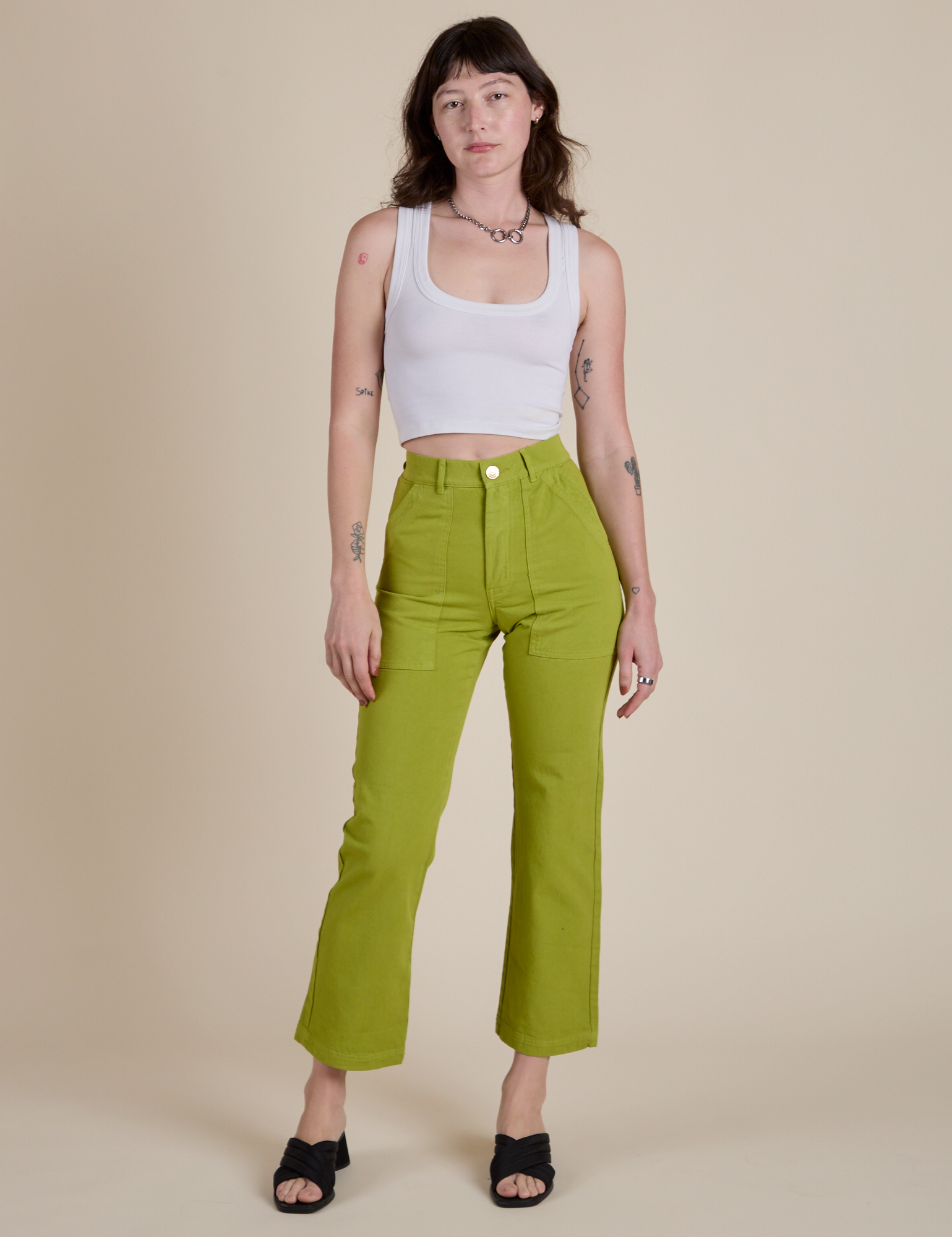 Alex is wearing Work Pants in Gross Green and vintage tee white Cropped Tank