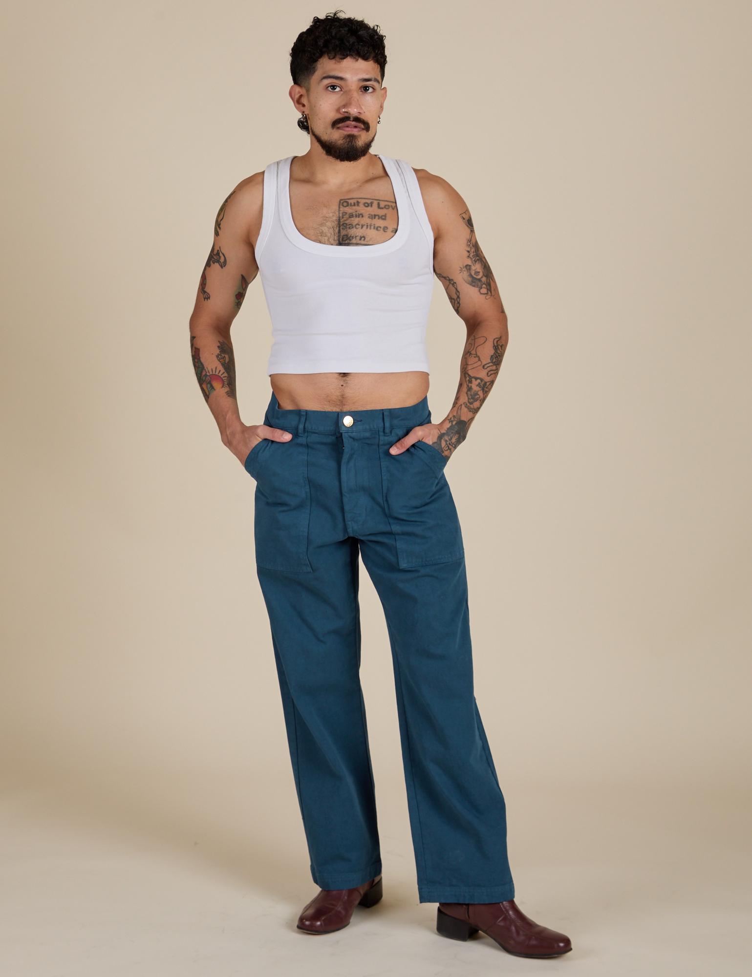 Jesse is wearing Work Pants in Lagoon paired with vintage tee white Cropped Tank