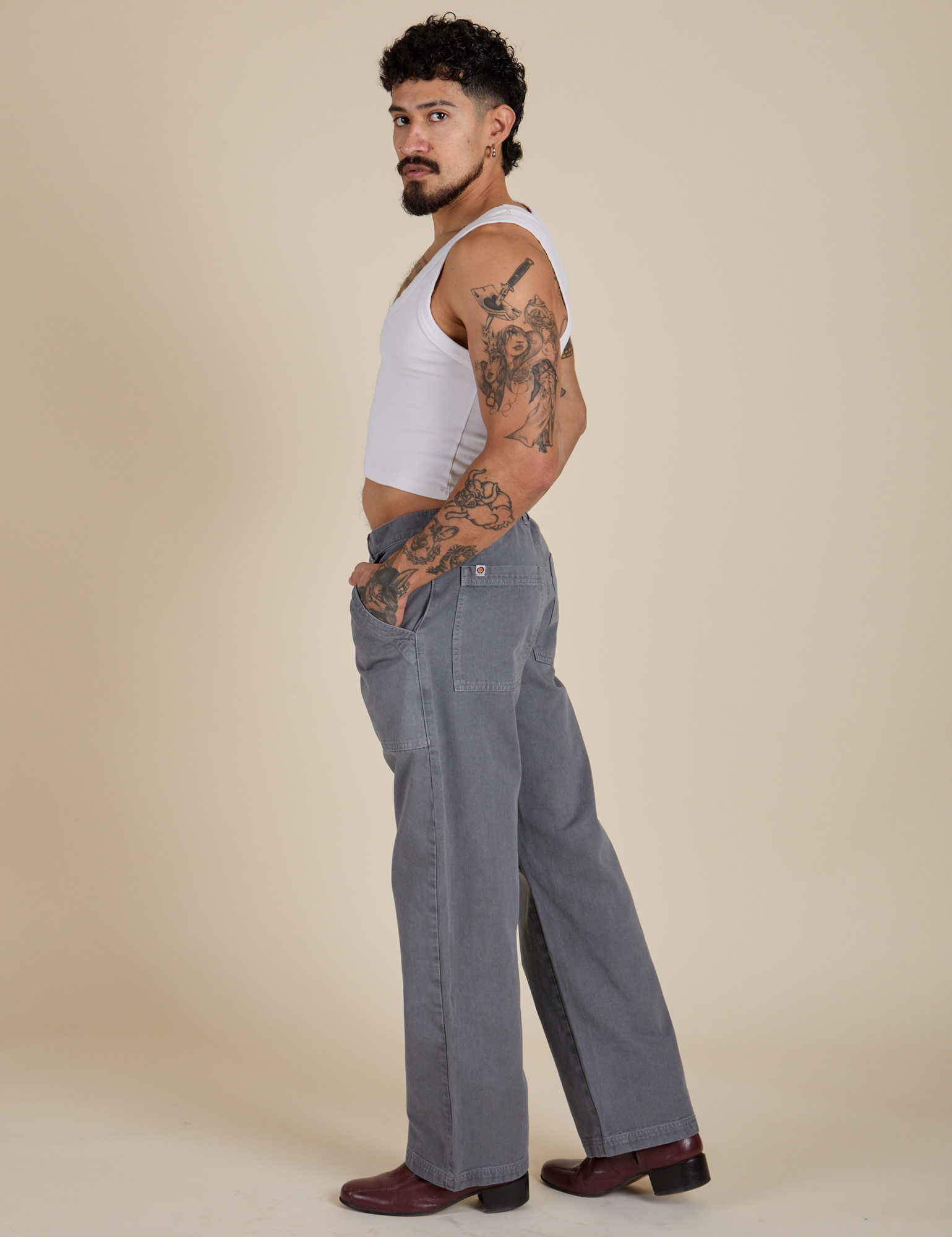 Side view of Work Pants in Washed Grey and Cropped Tank in Vintage Tee White on Jesse