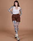 Sydney is wearing Classic Work Shorts in Fudgesicle Brown and a Cropped Tank in Vintage Tee White
