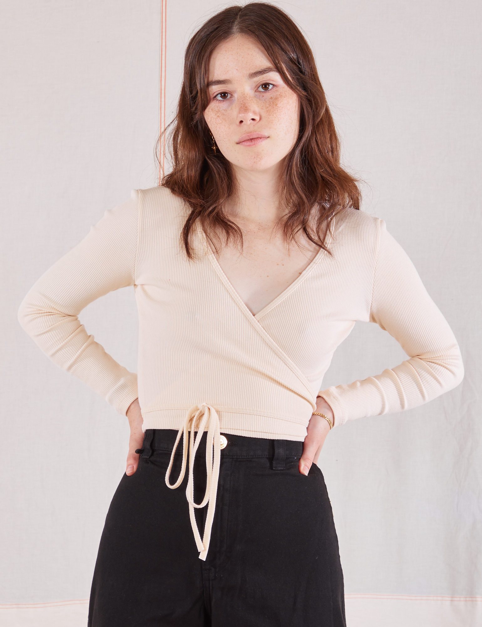 Hana is wearing Wrap Top in Vintage Tee Off-White