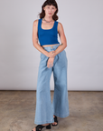 Alex is wearing Cropped Tank Top in Royal Blue and light wash Indigo Wide Leg Trousers