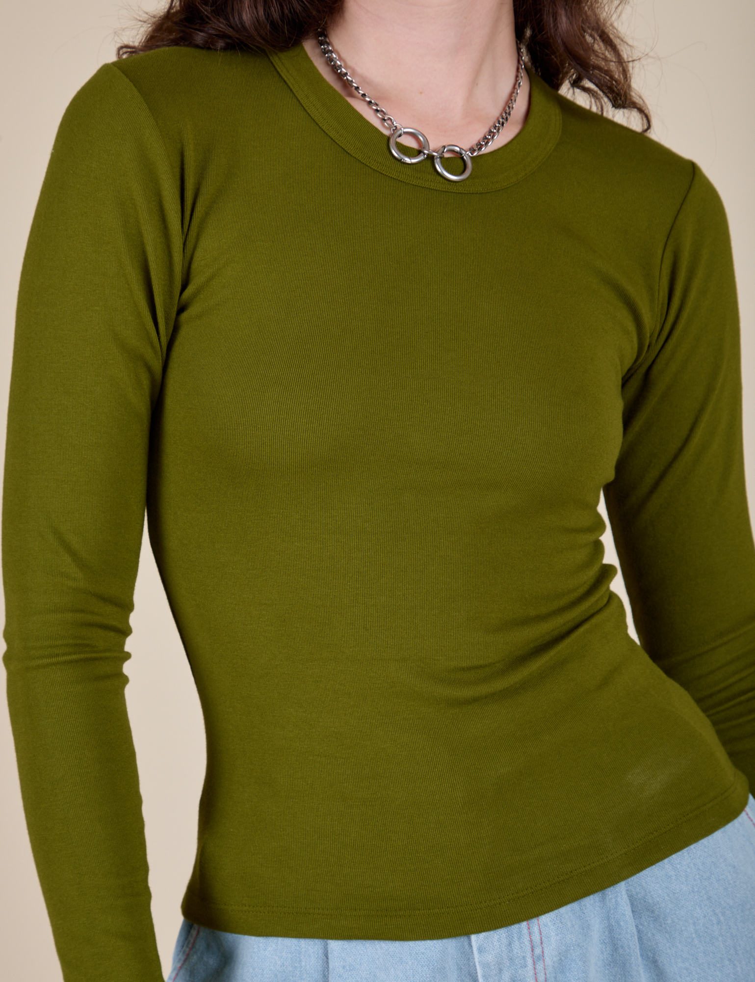 Long Sleeve Baby Tee in Summer Olive front close up on Alex