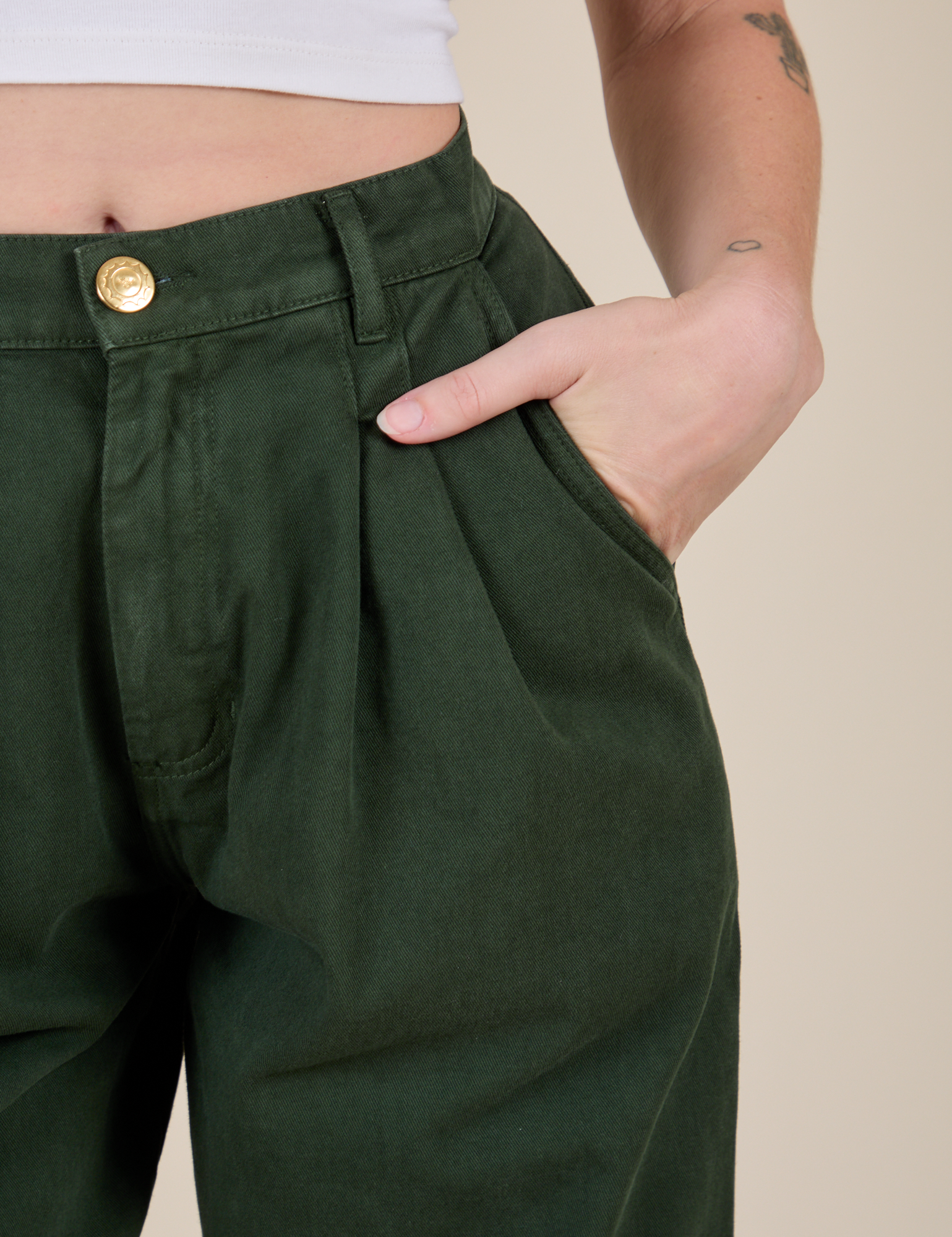 Close up of Alex's hand in the front pocket of Heavyweight Trousers in Swamp Green