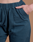 Close up of Alex's hand in the front pocket of Action Pants in Lagoon