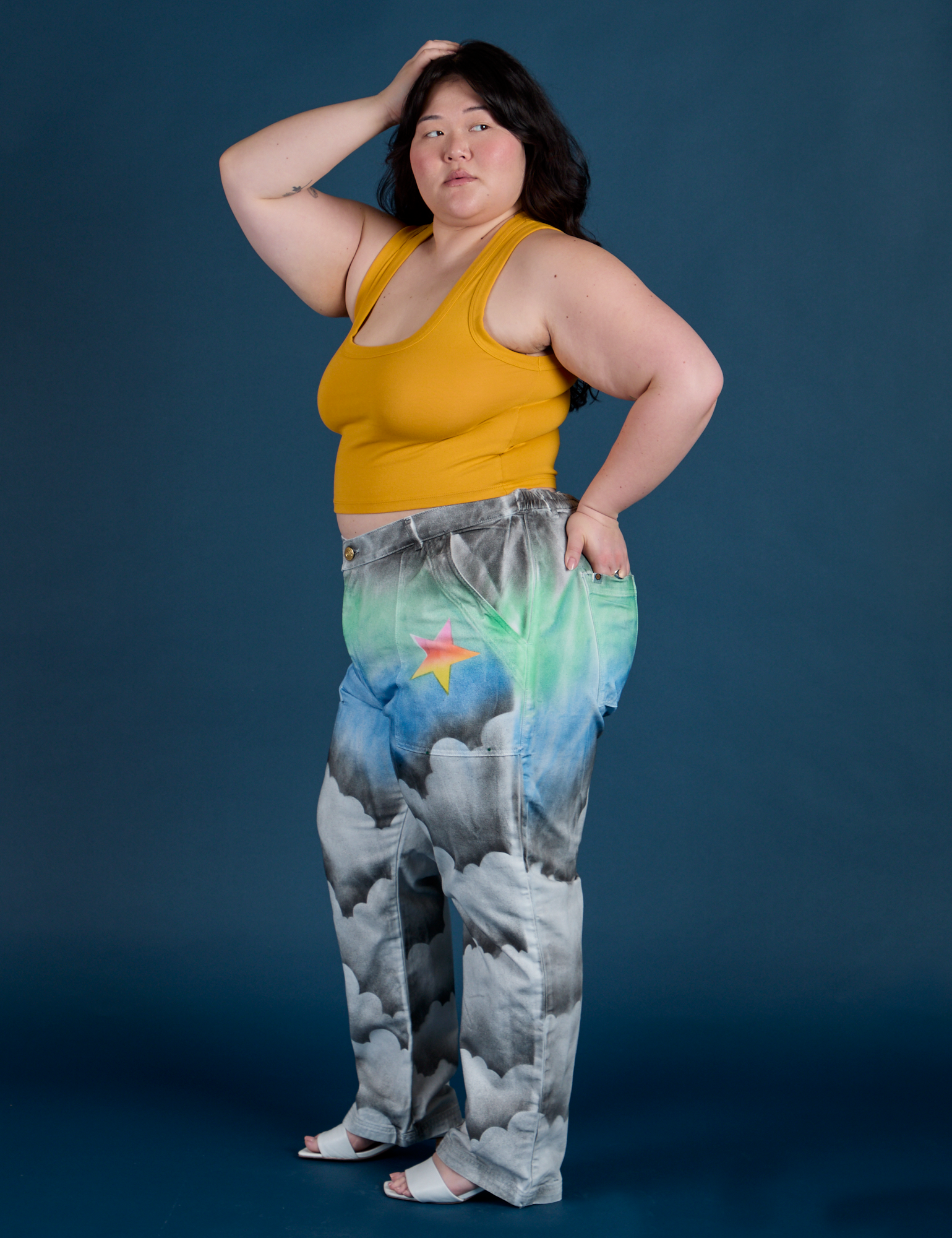 Side view of Work Pants in Night Sky Airbrush and mustard yellow Cropped Tank on Ashley