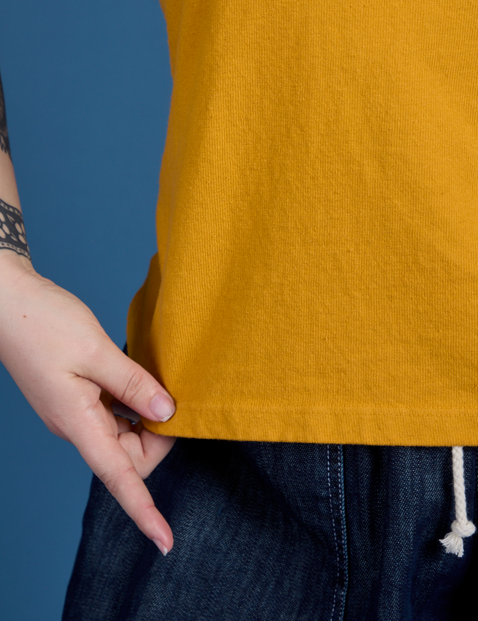 Painted Burly Tee in Mustard Yellow front bottom close up on Sydney