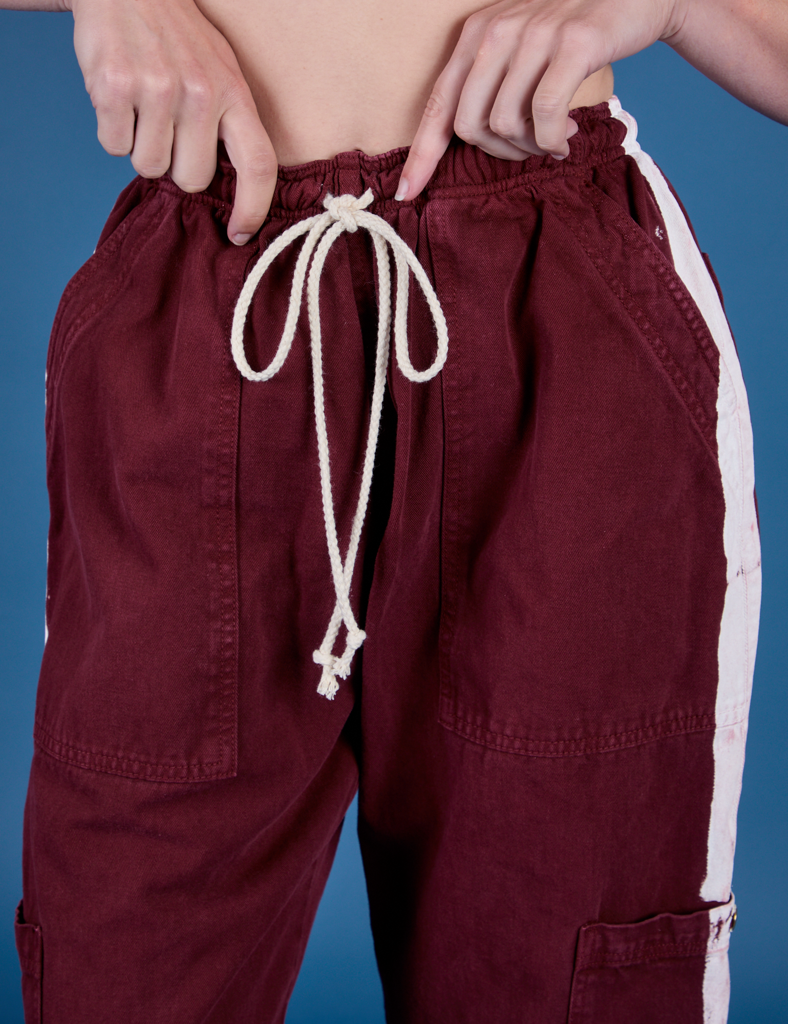 Painted Drop Pocket Cargo Pants in Red Wine front close up on Alex