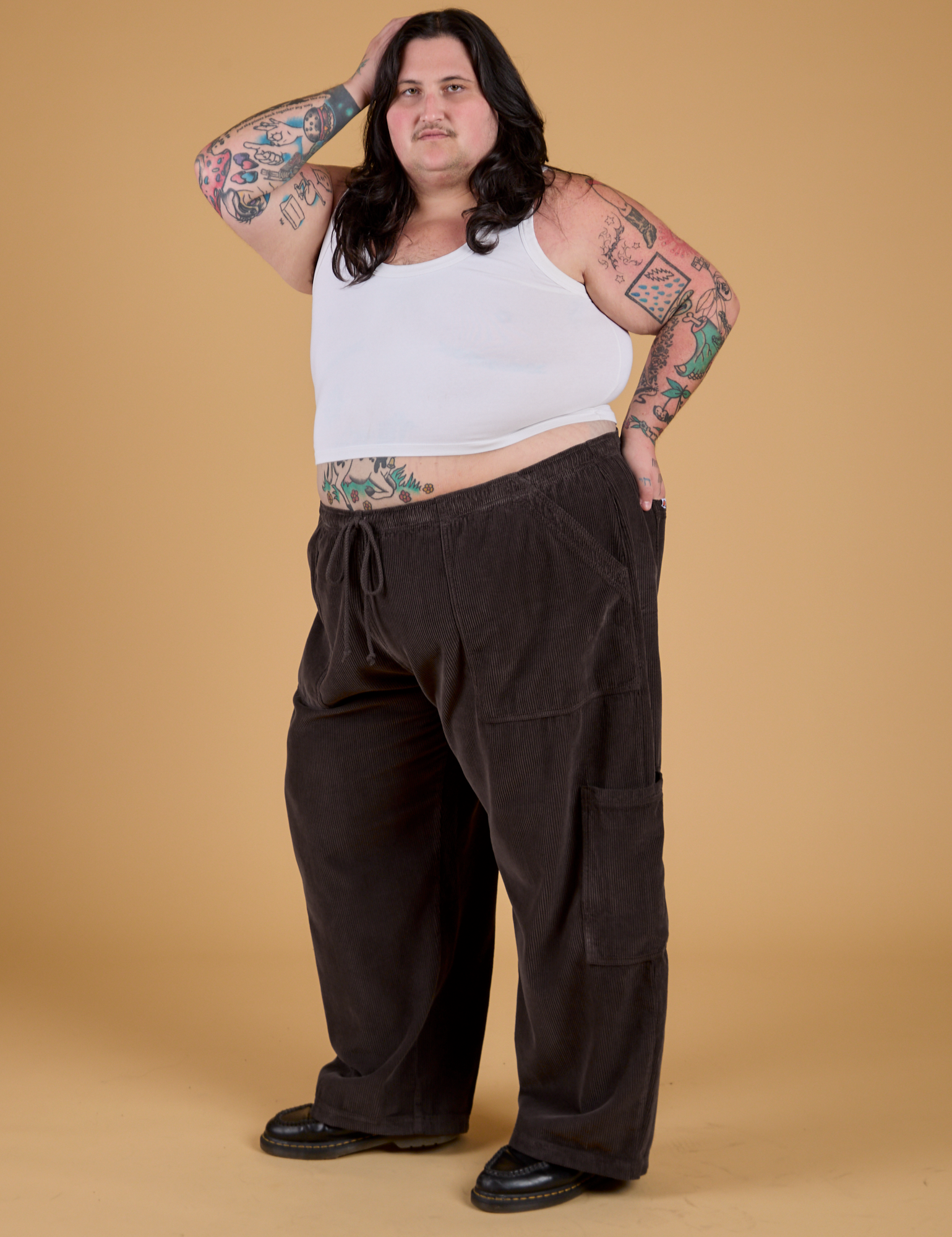 Angled front view of Corduroy Drop Pocket Cargo Pants in Espresso Brown and Cropped Tank in Vintage Tee White on Sam