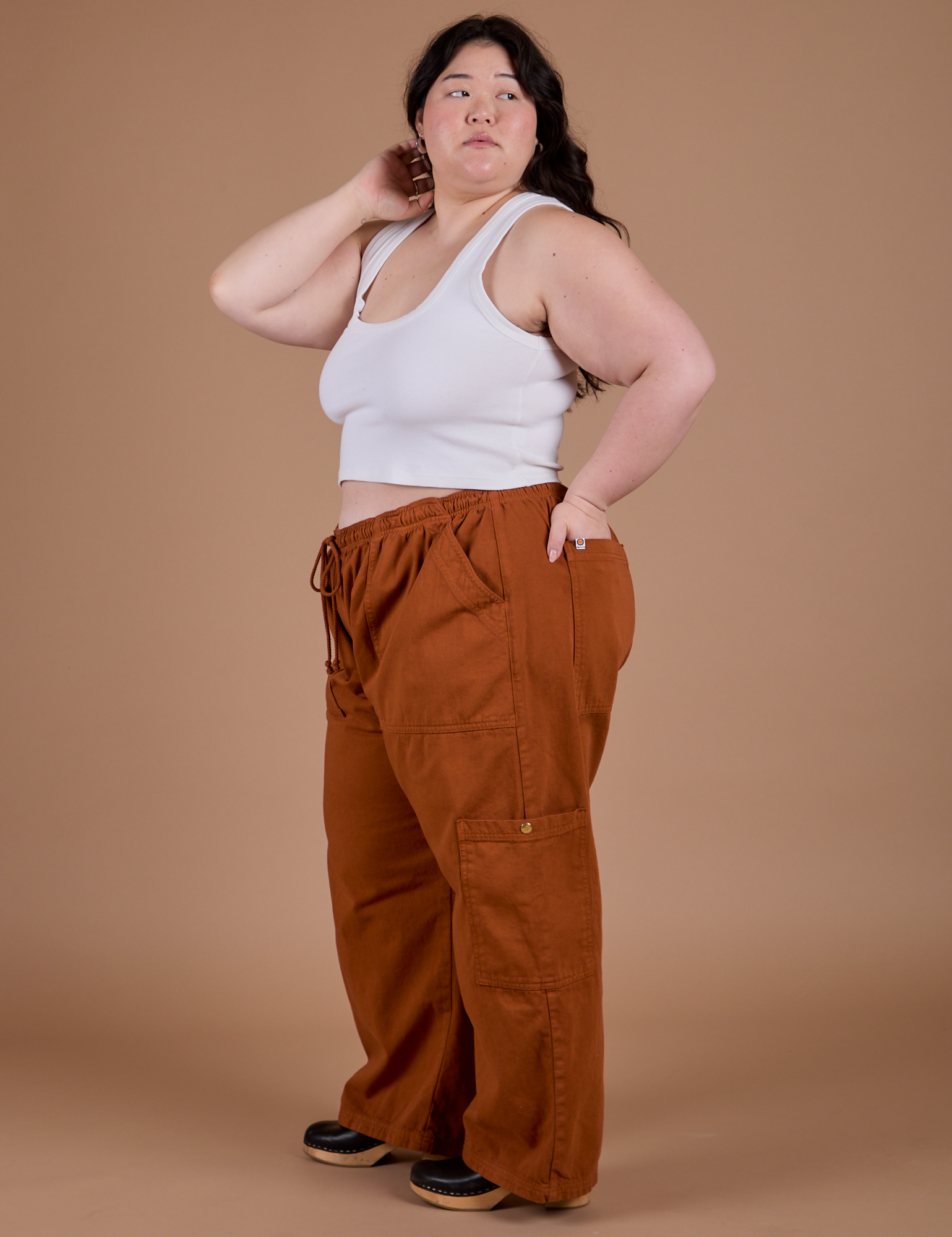 Side view of Drop Pocket Cargo Pants in Burnt Terracotta and vintage tee white Cropped Tank on Ashley