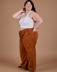 Side view of Drop Pocket Cargo Pants in Burnt Terracotta and vintage tee white Cropped Tank on Ashley