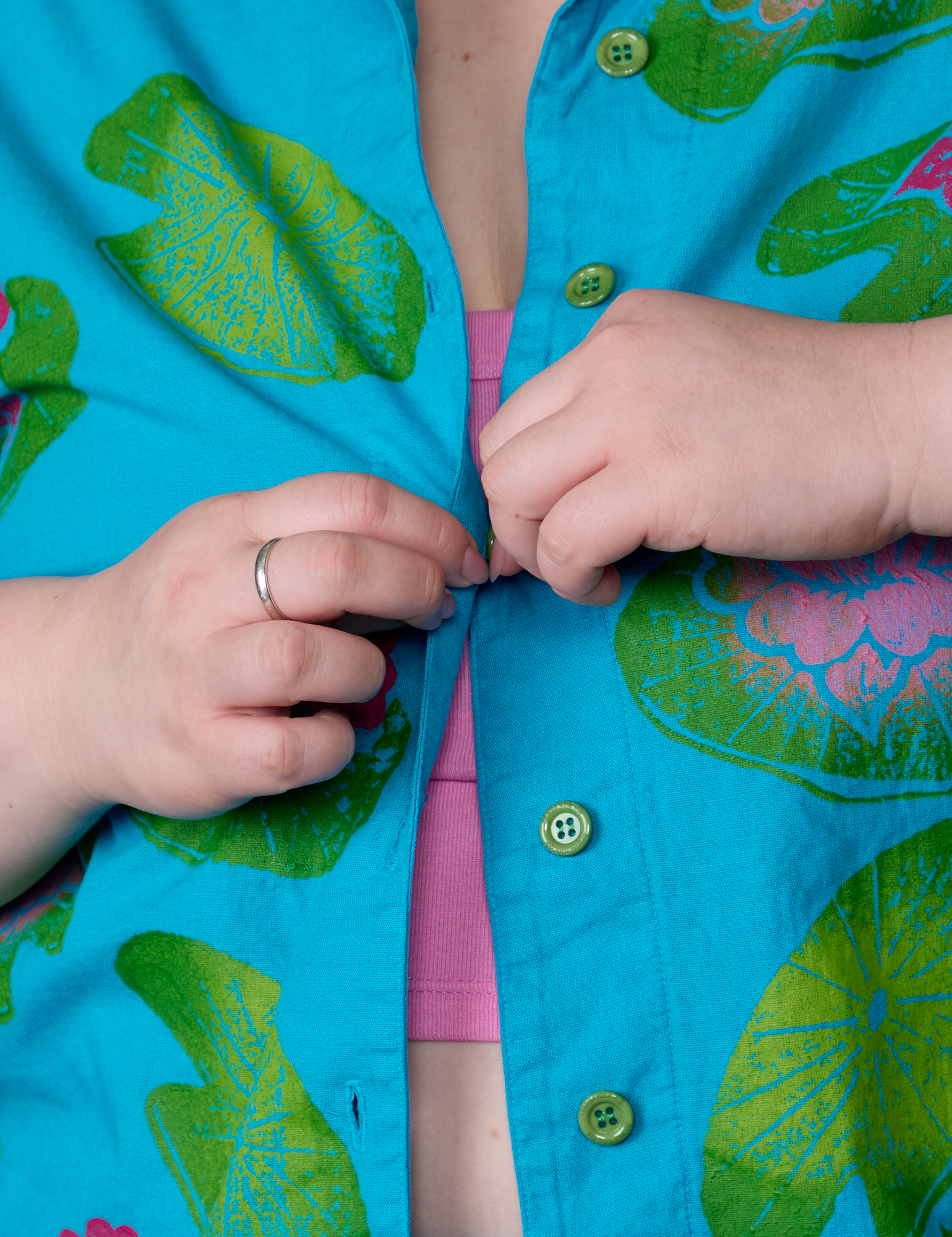 Close up of Ashley buttoning the Paintstamped Pantry Button-Up in Lilypad