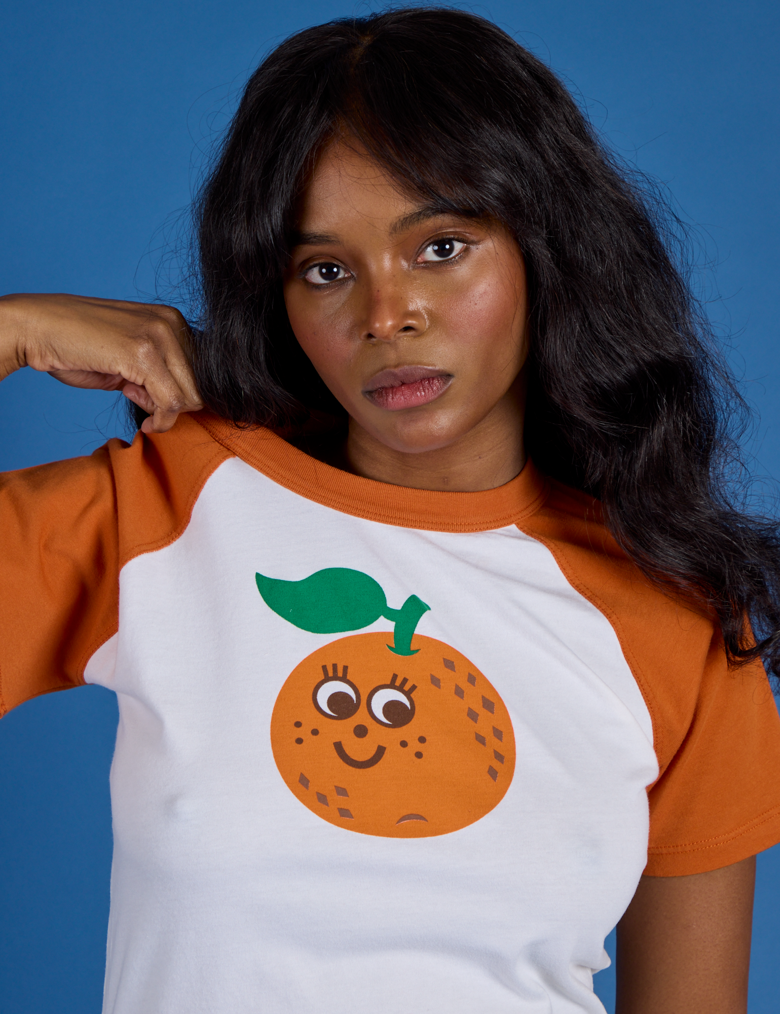Front close up of Produce Raglan Tee in Orange on Kandia