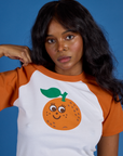 Front close up of Produce Raglan Tee in Orange on Kandia