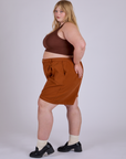 Side view of Pleated Trouser Shorts in Burnt Terracotta and fudgesicle brown Mini Tank on Juliet