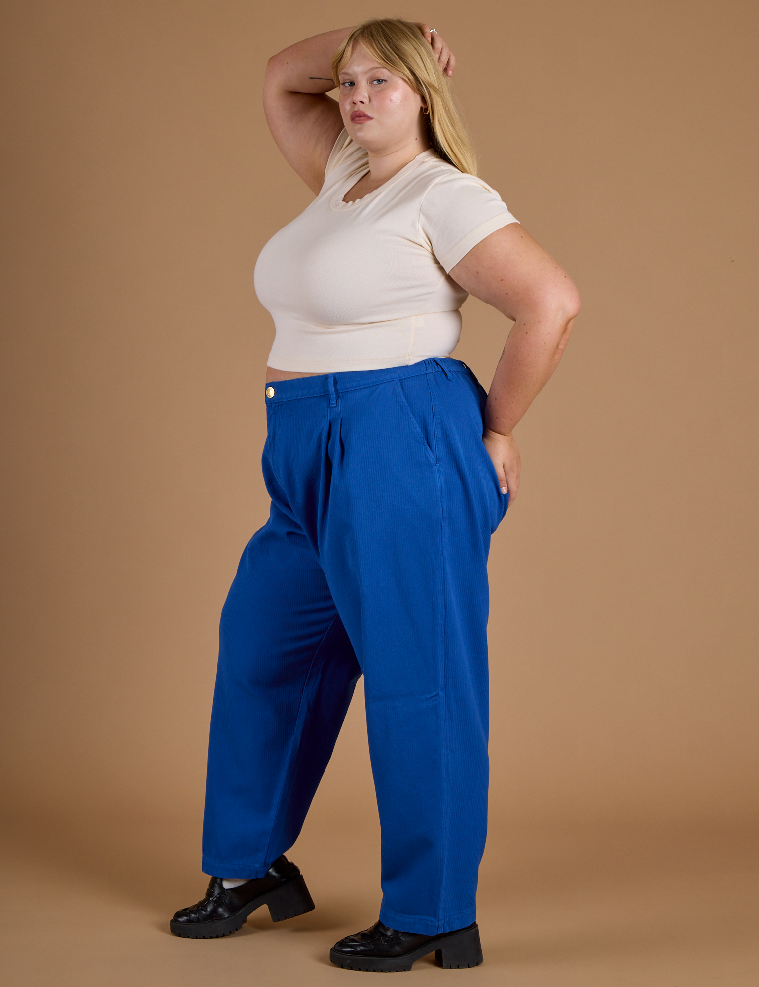 Side view of Heritage Trousers in Royal Blue and Organic Vintage Tee in Vintage Off White on Juliet
