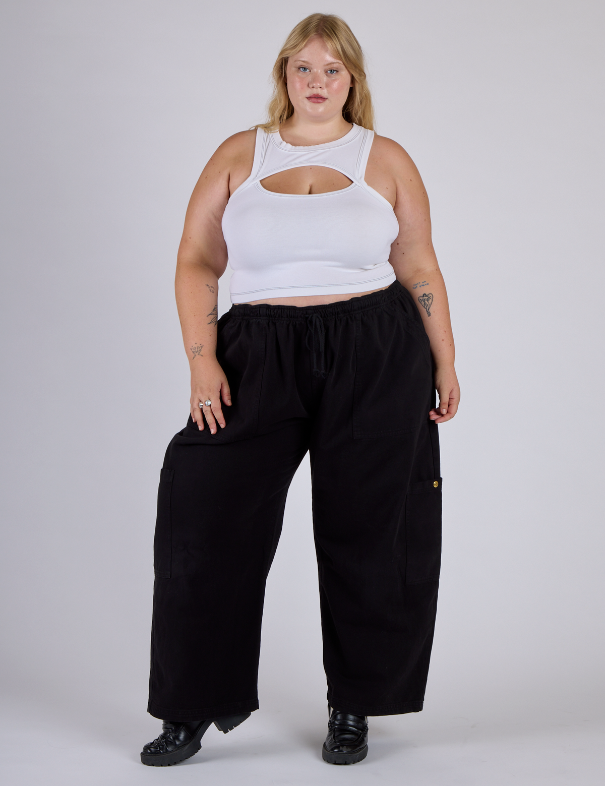 Juliet is wearing the Vintage Tee White Porthole Tank and Black Drop Pocket Cargo Pants