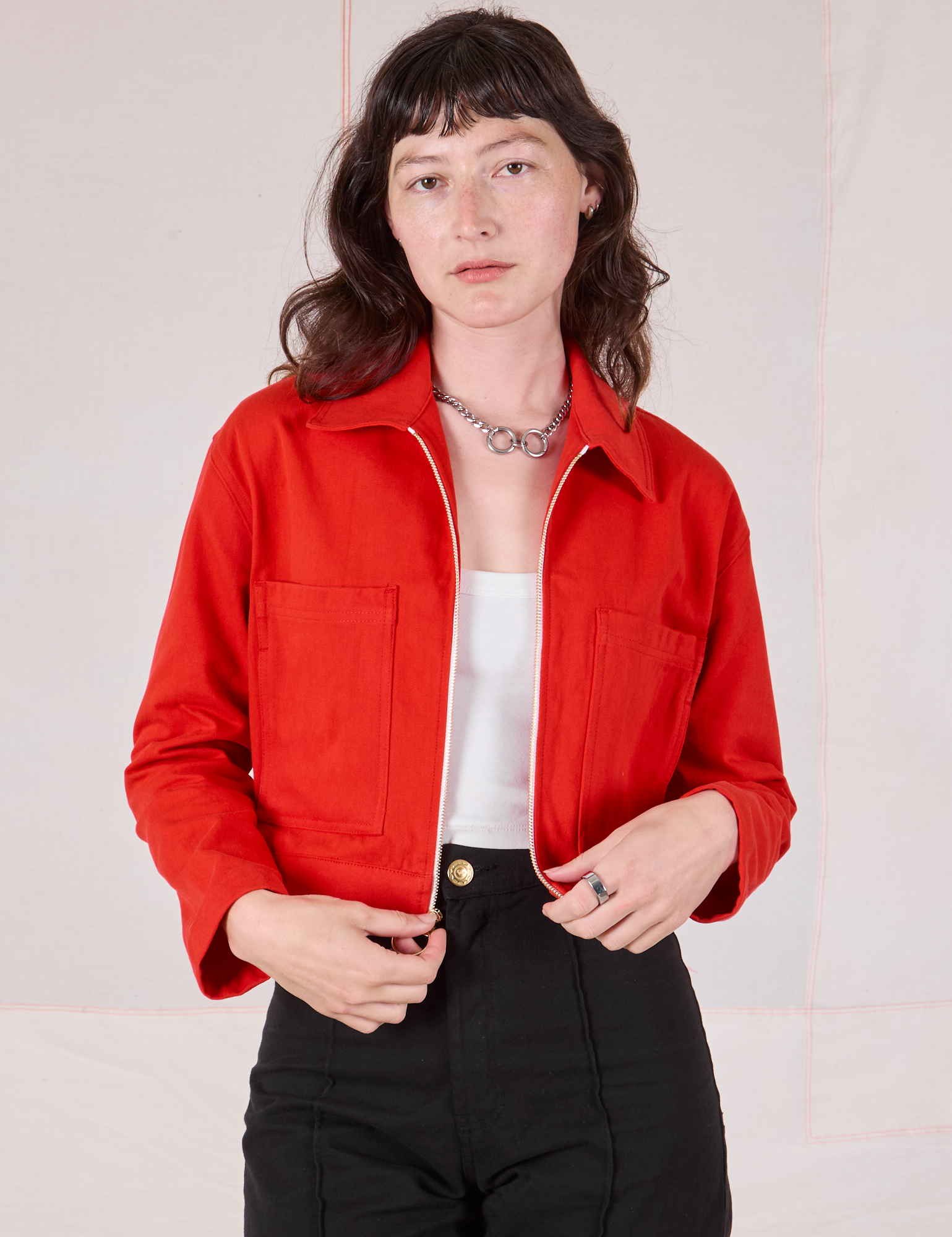 Alex is wearing Mechanic Jacket in Mustang Red