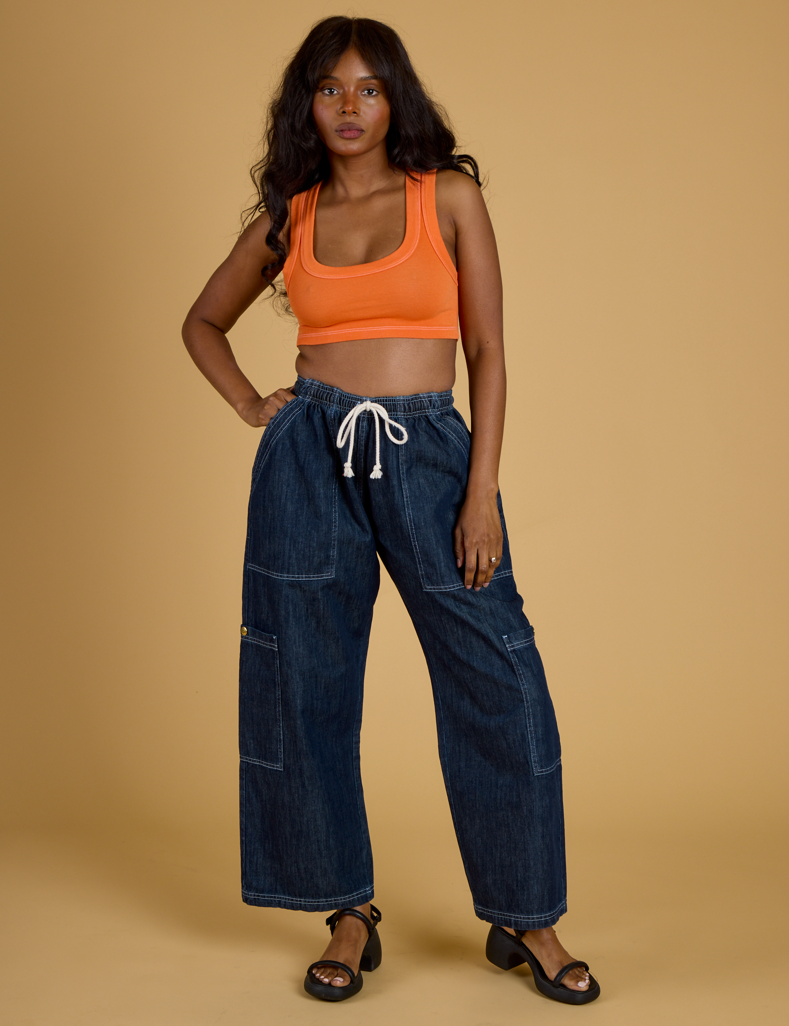 Kandia is wearing Contrast Stitch Mini Tank in Construction Orange and dark wash Denim Drop Pocket Pants