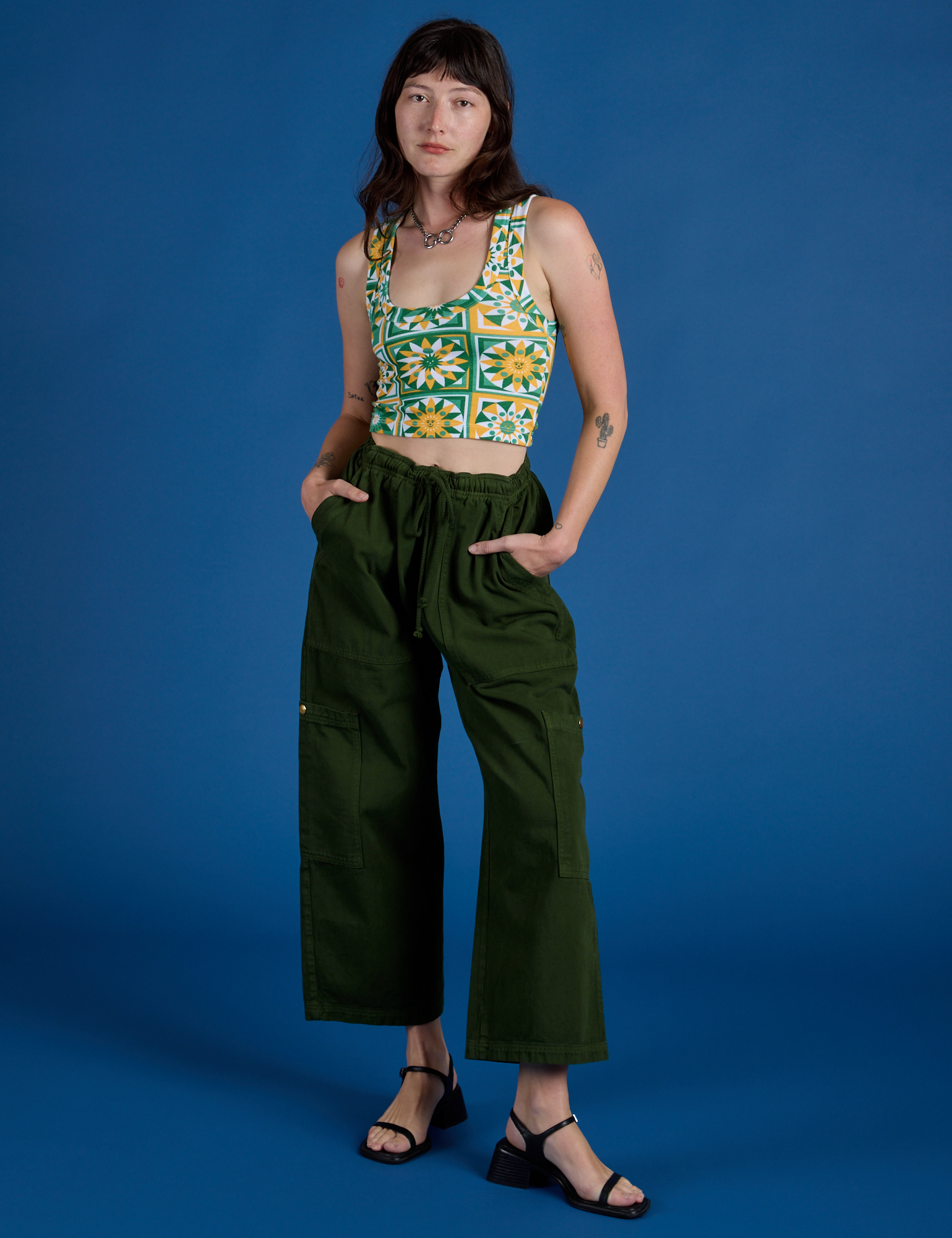 Alex is wearing Cropped Tank Top in Spring Quilt Print and evergreen Drop Pocket Cargo Pants