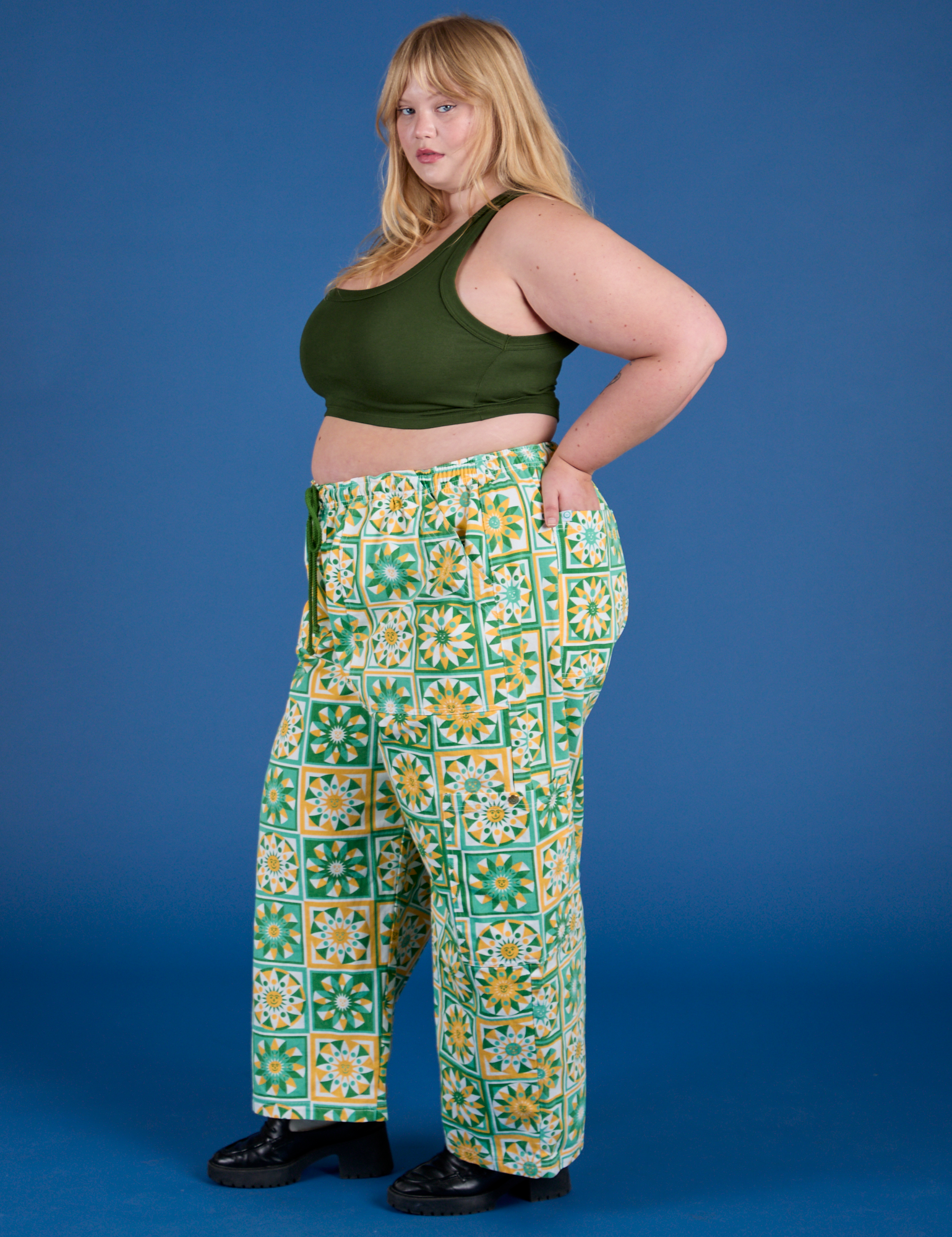Side view of Drop Pocket Cargo Pants in Spring Quilt Print paired with evergreen Mini Tank