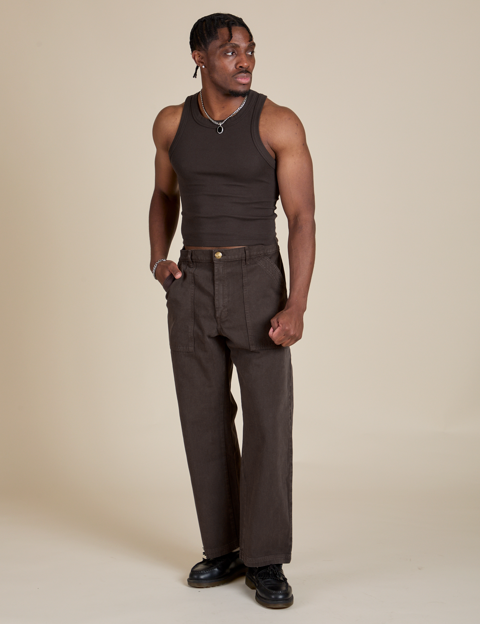 Isaac is wearing Racerback Tank in Espresso Brown and matching Work Pants