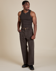 Isaac is wearing Racerback Tank in Espresso Brown and matching Work Pants