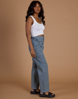 Side view of Railroad Denim Work Pants in Natural and vintage tee white Cropped Tank on Kandia