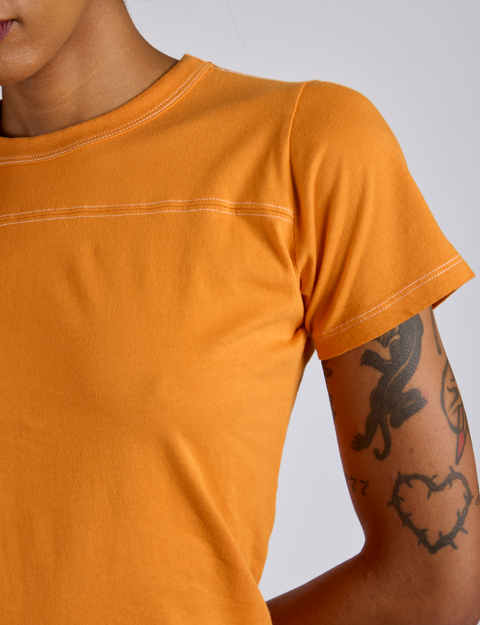 Jr. Varsity Tee in Creamsicle Orange close up on Kira